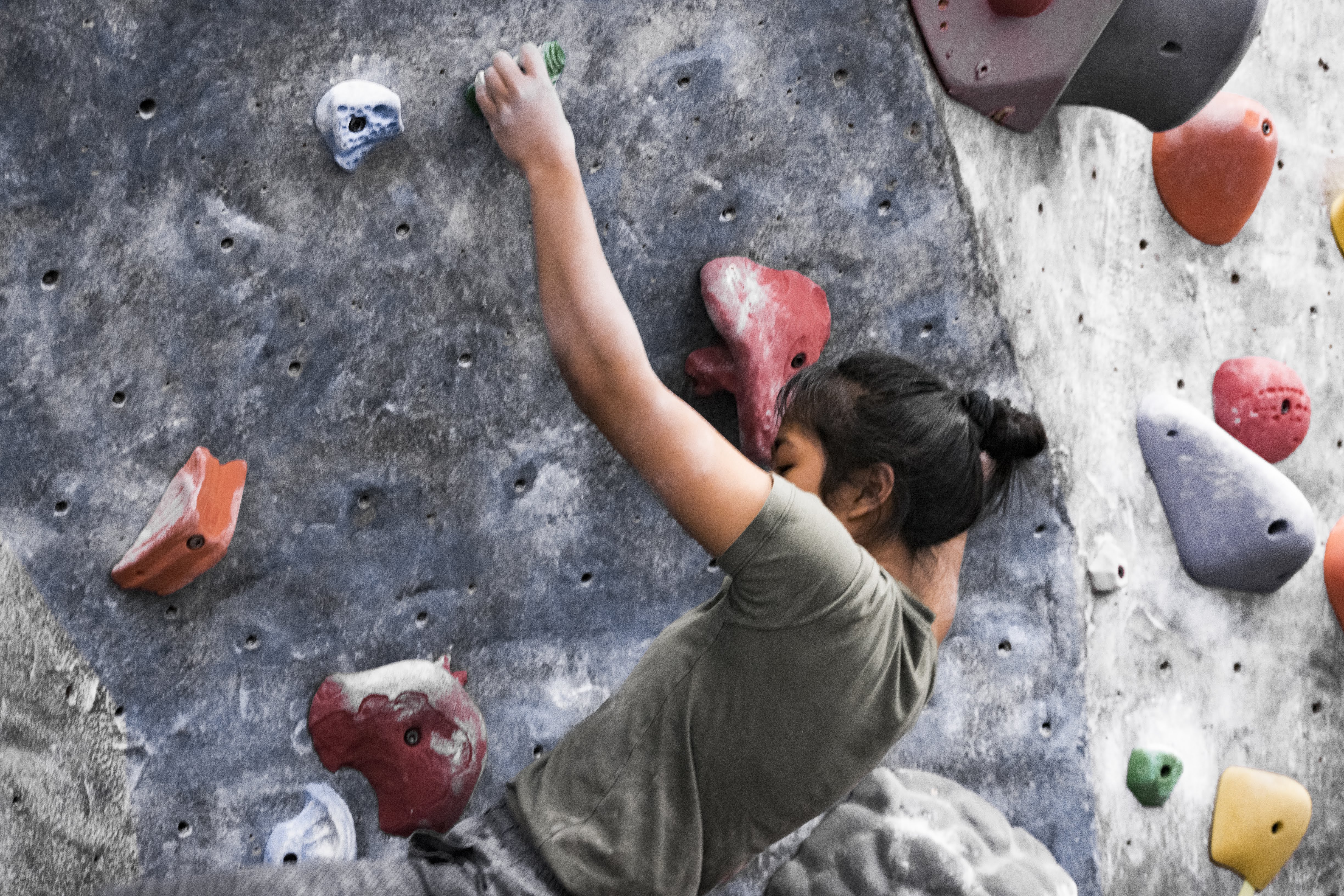 Rock climbing up bouldering wall